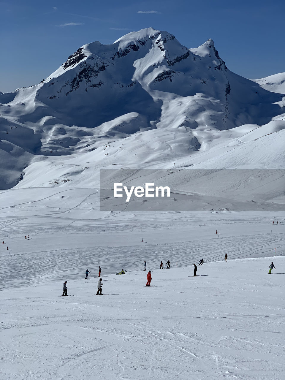 People skiing on snow covered mountain on grindelwald