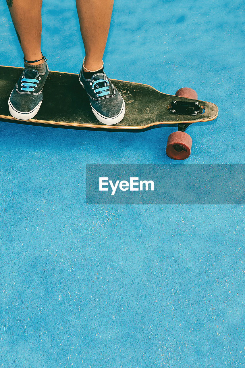 Teenager on skateboard in blue location