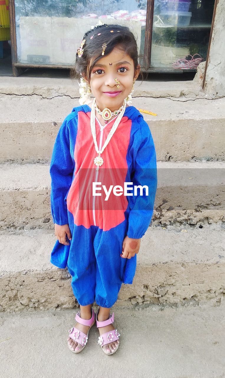 Portrait of girl wearing jewelries standing outdoors