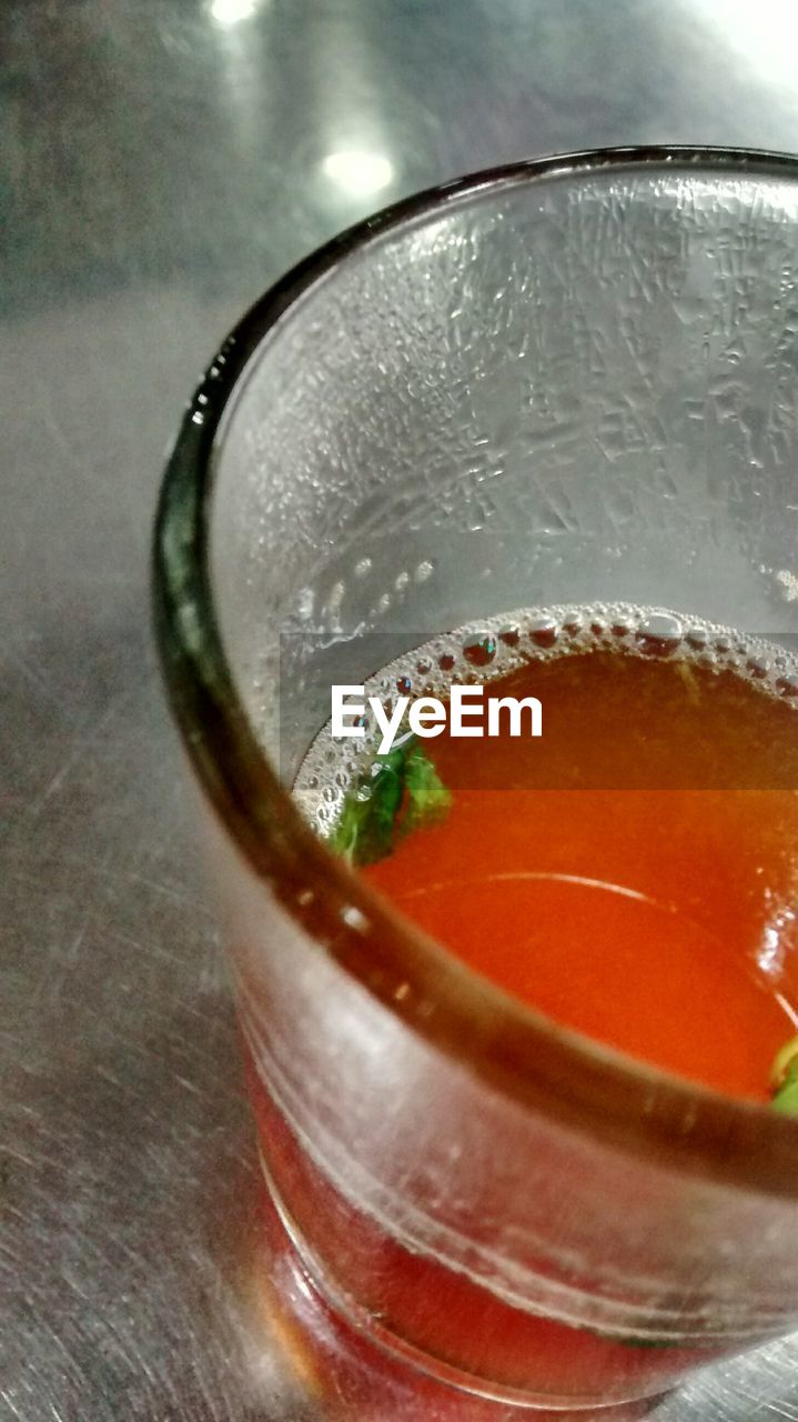 High angle view of cropped herbal tea on table