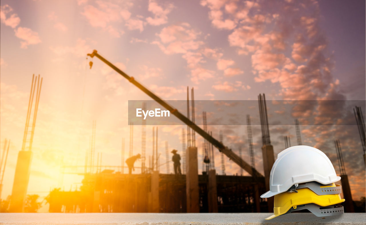 CONSTRUCTION SITE AGAINST SKY DURING SUNSET