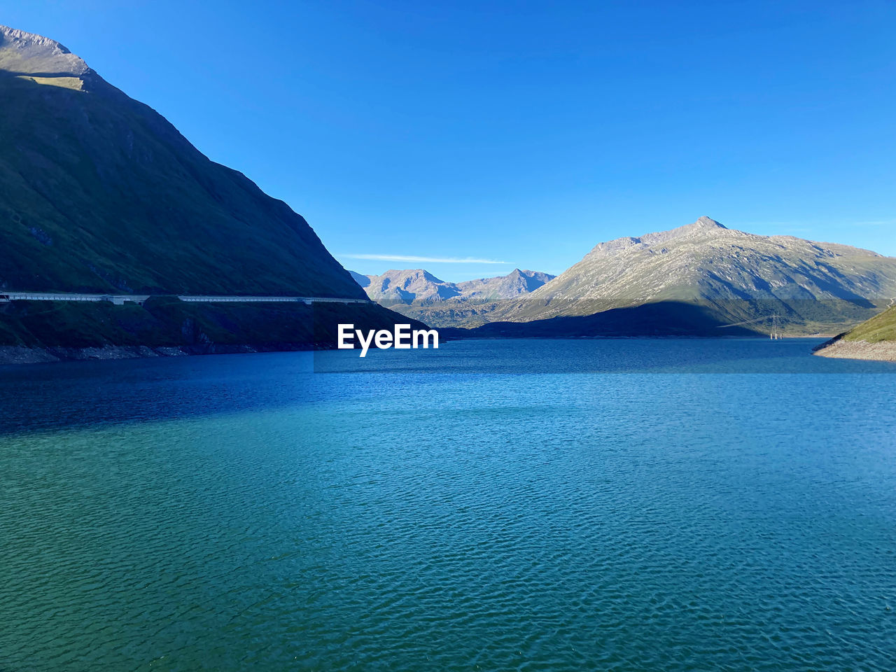 mountain, scenics - nature, water, beauty in nature, landscape, environment, blue, sky, nature, mountain range, travel destinations, tranquil scene, lake, land, tranquility, no people, travel, cold temperature, snow, glacial landform, non-urban scene, clear sky, idyllic, day, outdoors, lagoon, winter, tourism, bay