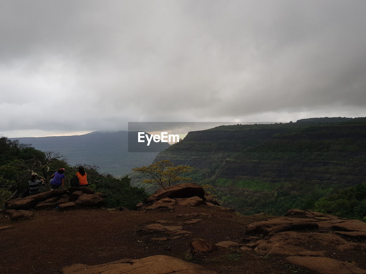 MAN ON MOUNTAINS AGAINST SKY