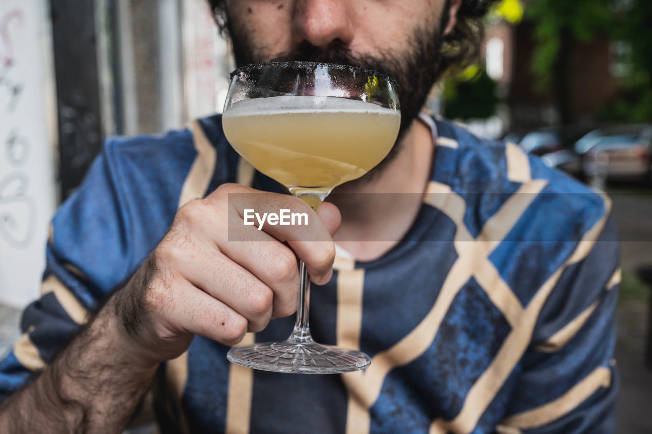 Close-up of man drinking beer