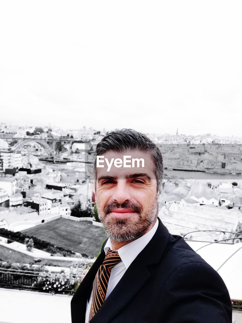 PORTRAIT OF MAN AGAINST CITYSCAPE