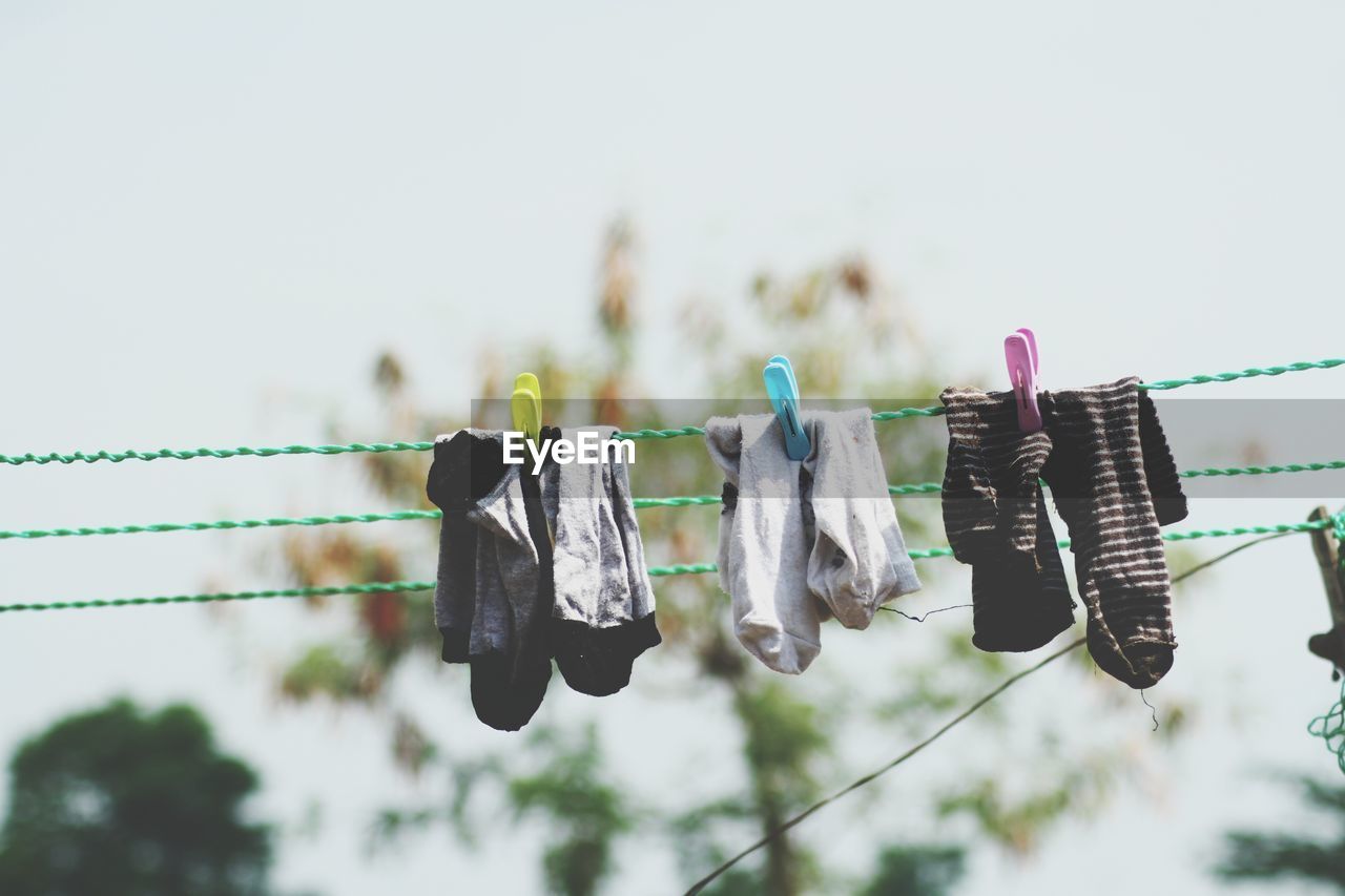 Low angle view of clothes drying on clothesline against sky