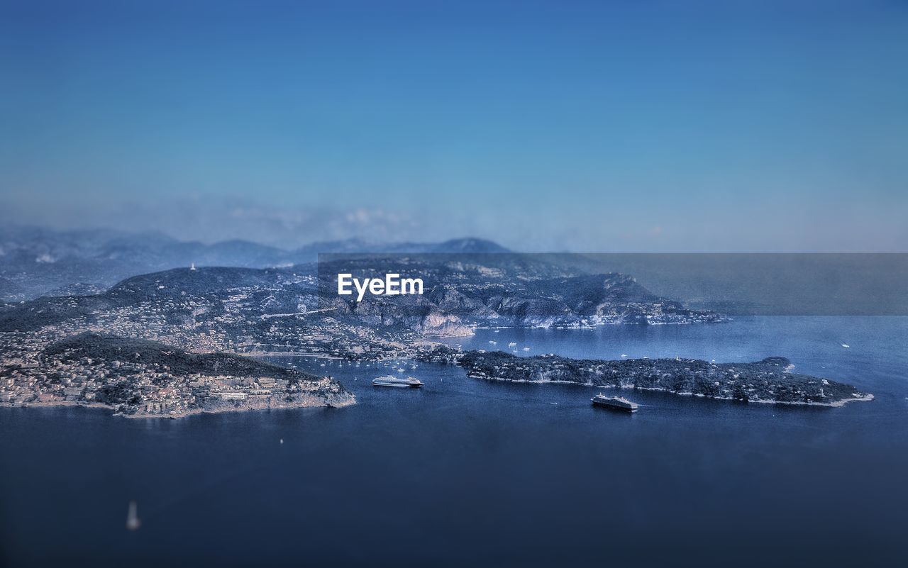 Aerial view of sea against blue sky