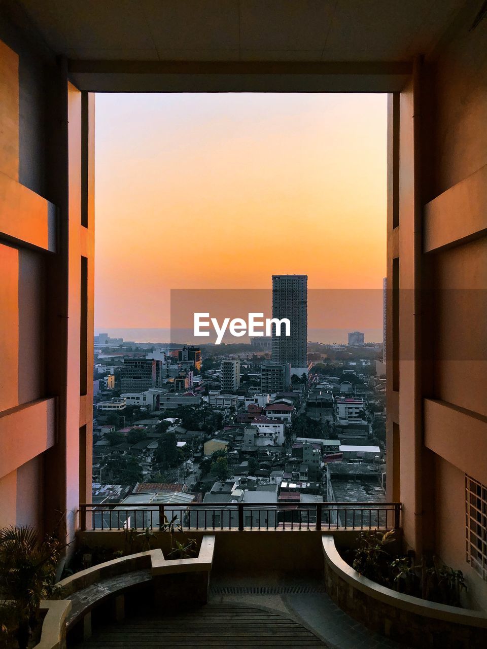 Modern buildings against sky during sunset