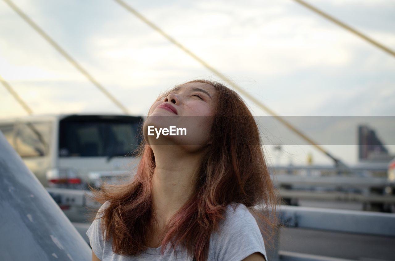 Close-up of tensed woman standing on highway