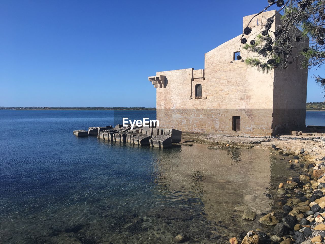 BUILDING BY SEA AGAINST CLEAR SKY