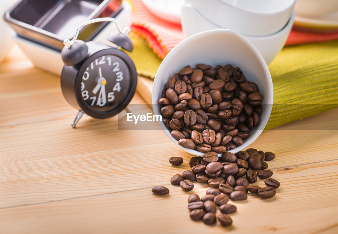 Close-up of coffee beans spilling on table