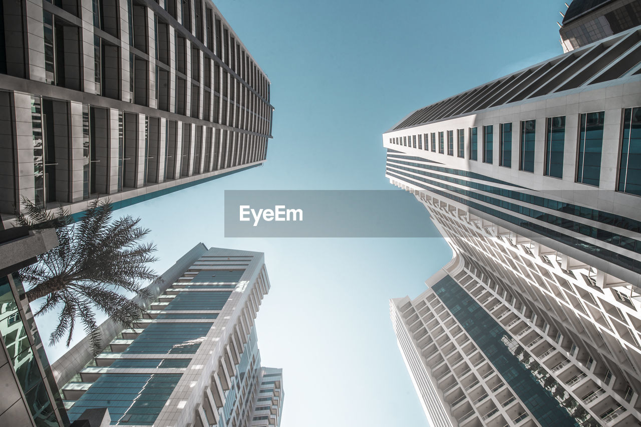 LOW ANGLE VIEW OF MODERN BUILDINGS AGAINST CLEAR SKY