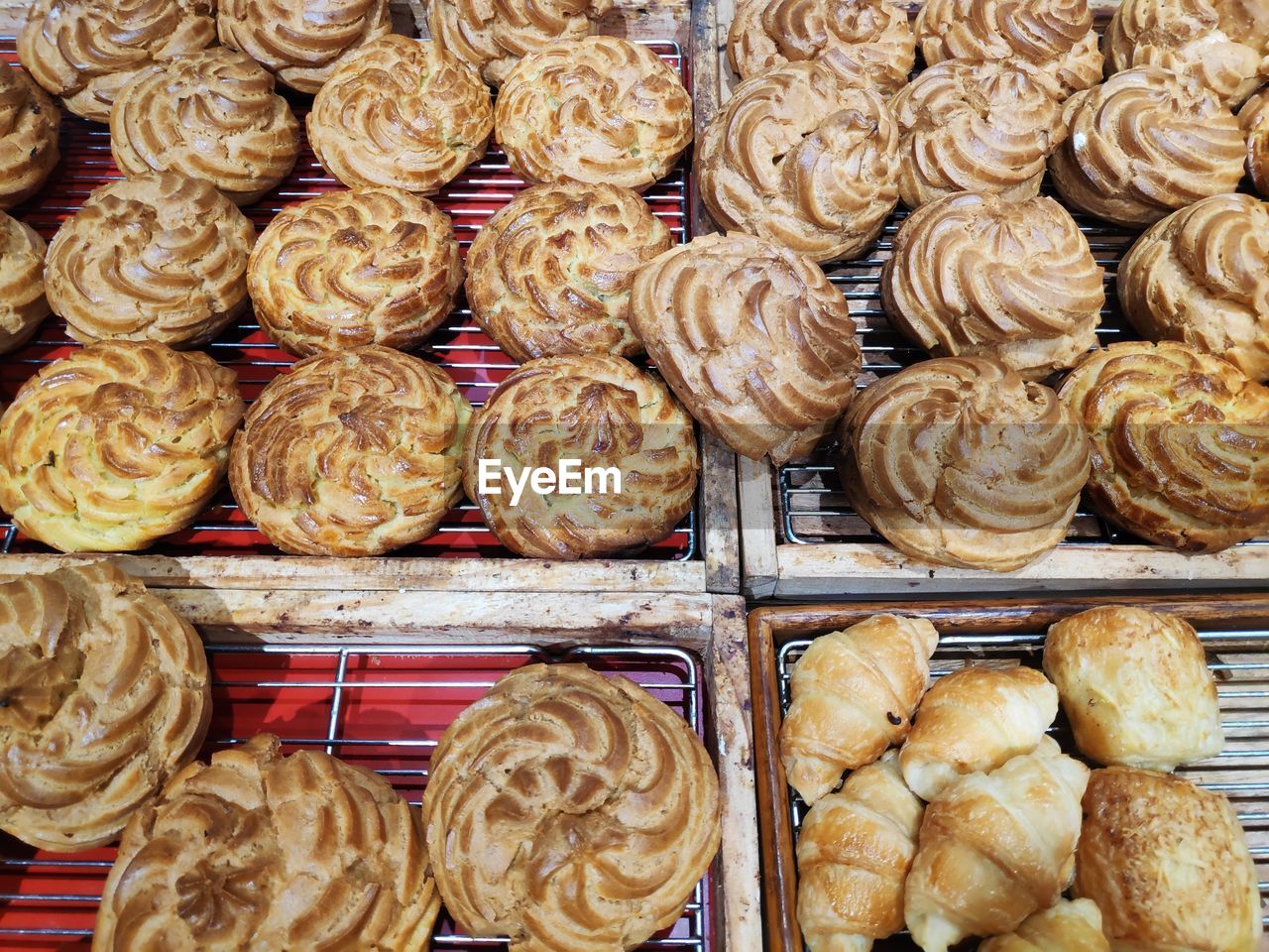 High angle view of sweet food on cooling racks in bakery