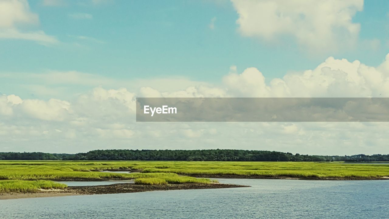 Scenic view of lake against cloudy sky