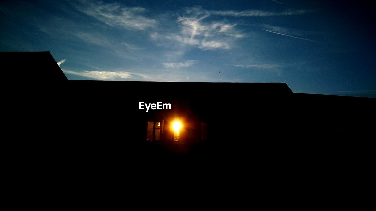 SILHOUETTE OF BUILDING AGAINST SKY AT NIGHT