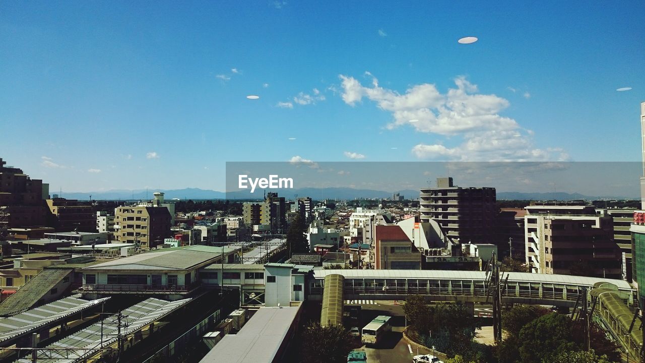 VIEW OF CITYSCAPE AGAINST BLUE SKY