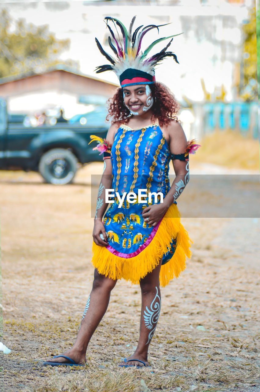 Full length of smiling woman wearing costume