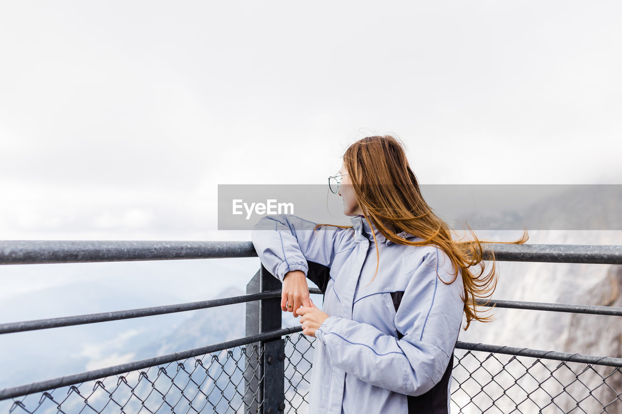 Young girl enjoys the views of the alps from the observation deck