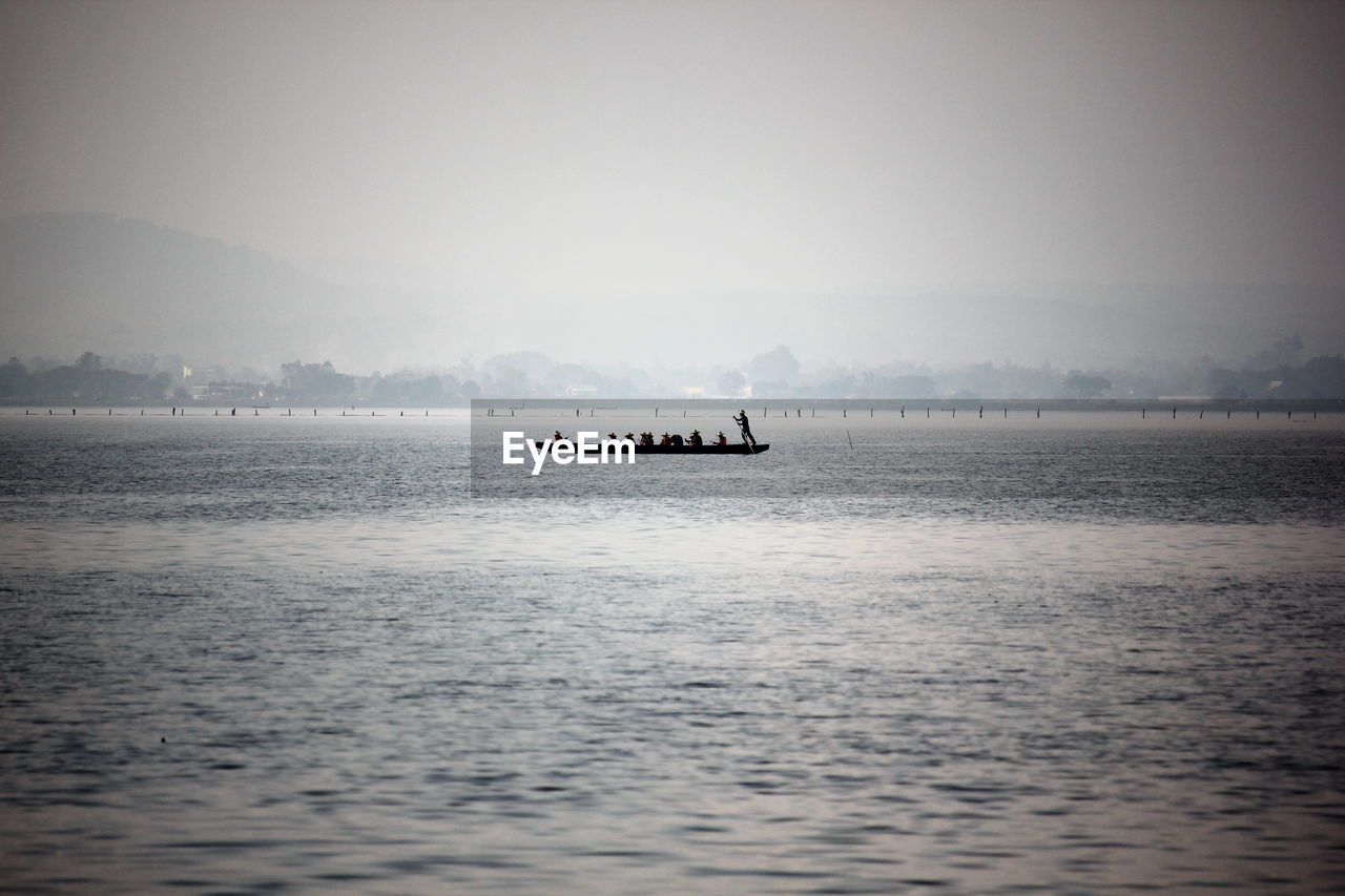 Boat sailing in sea against sky