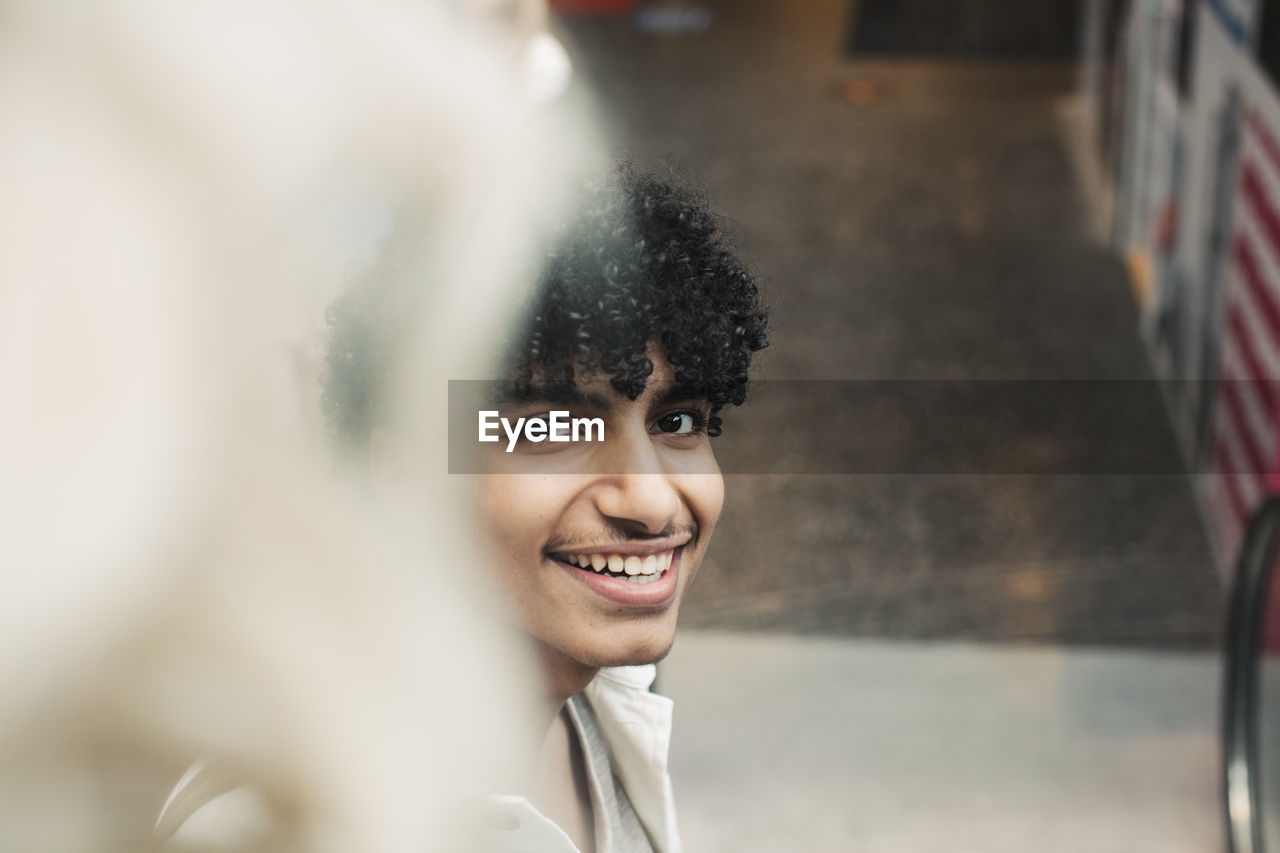 Portrait of smiling teenager boy in shopping mall