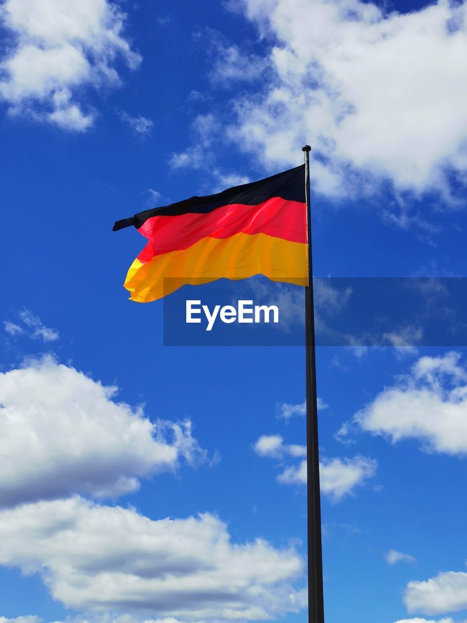 Low angle view of german flag against sky
