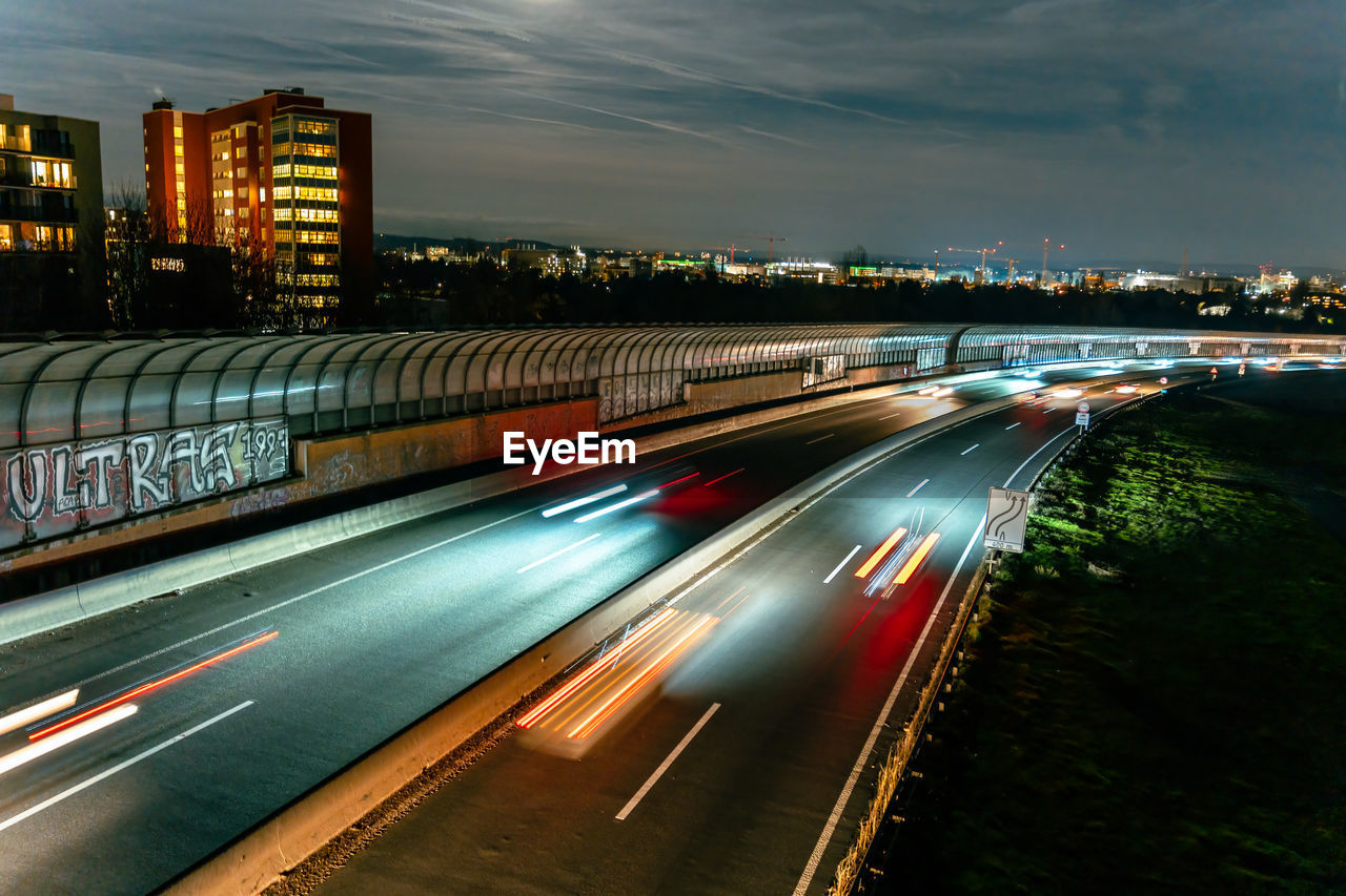 high angle view of light trails on highway in city at night