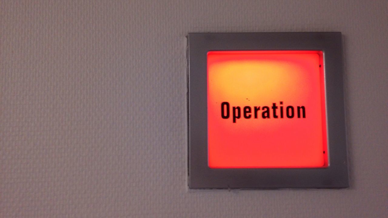 Low angle view of illuminated operation sign