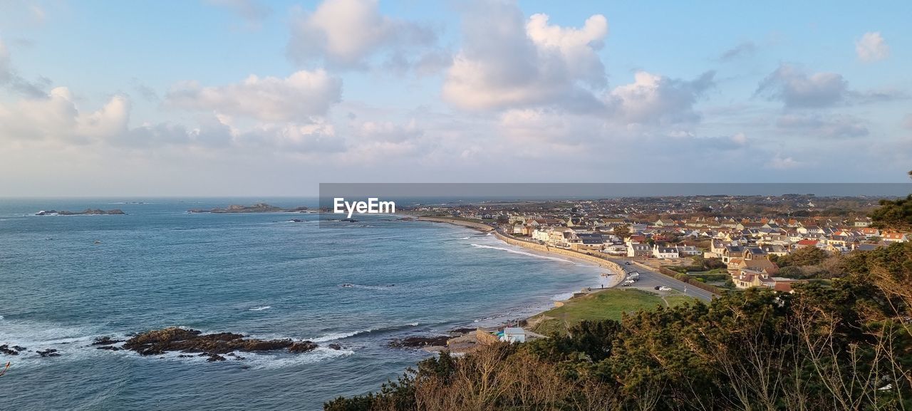 sea, water, sky, coast, land, beach, shore, body of water, architecture, cloud, horizon, nature, city, ocean, building exterior, built structure, travel destinations, travel, building, scenics - nature, coastline, beauty in nature, environment, landscape, tourism, cliff, panoramic, outdoors, no people, vacation, plant, horizon over water, bay, trip, terrain, day, holiday, cityscape, high angle view, urban skyline, sports, blue, motion, tranquility, tree, seascape