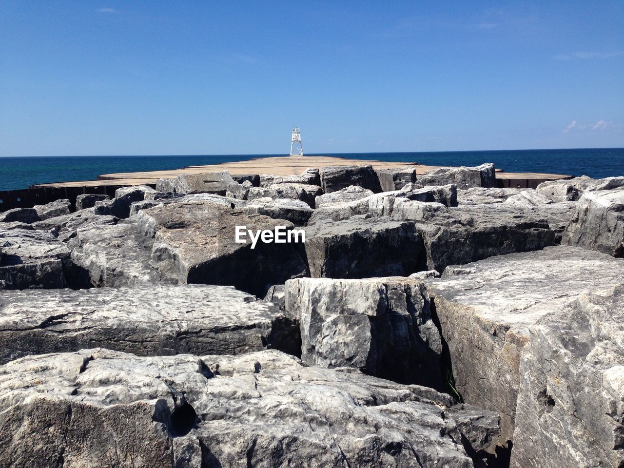 Groyne in sea against sky