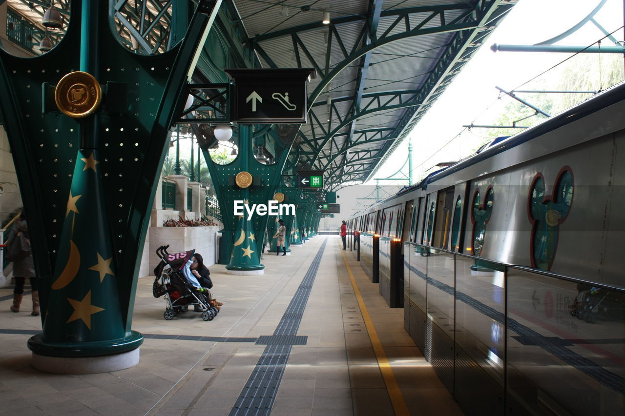 People at railroad station in city