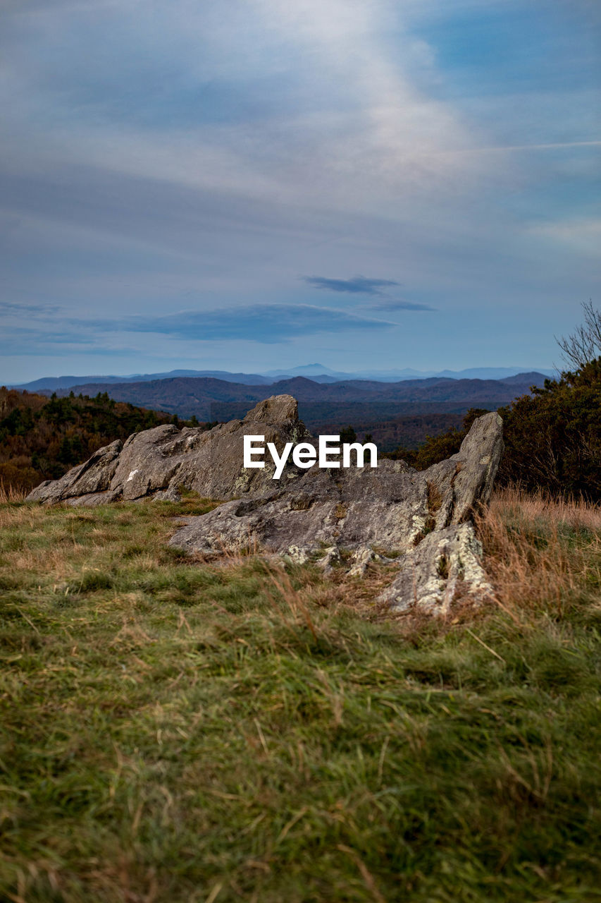 Scenic view of rocks on field against sky