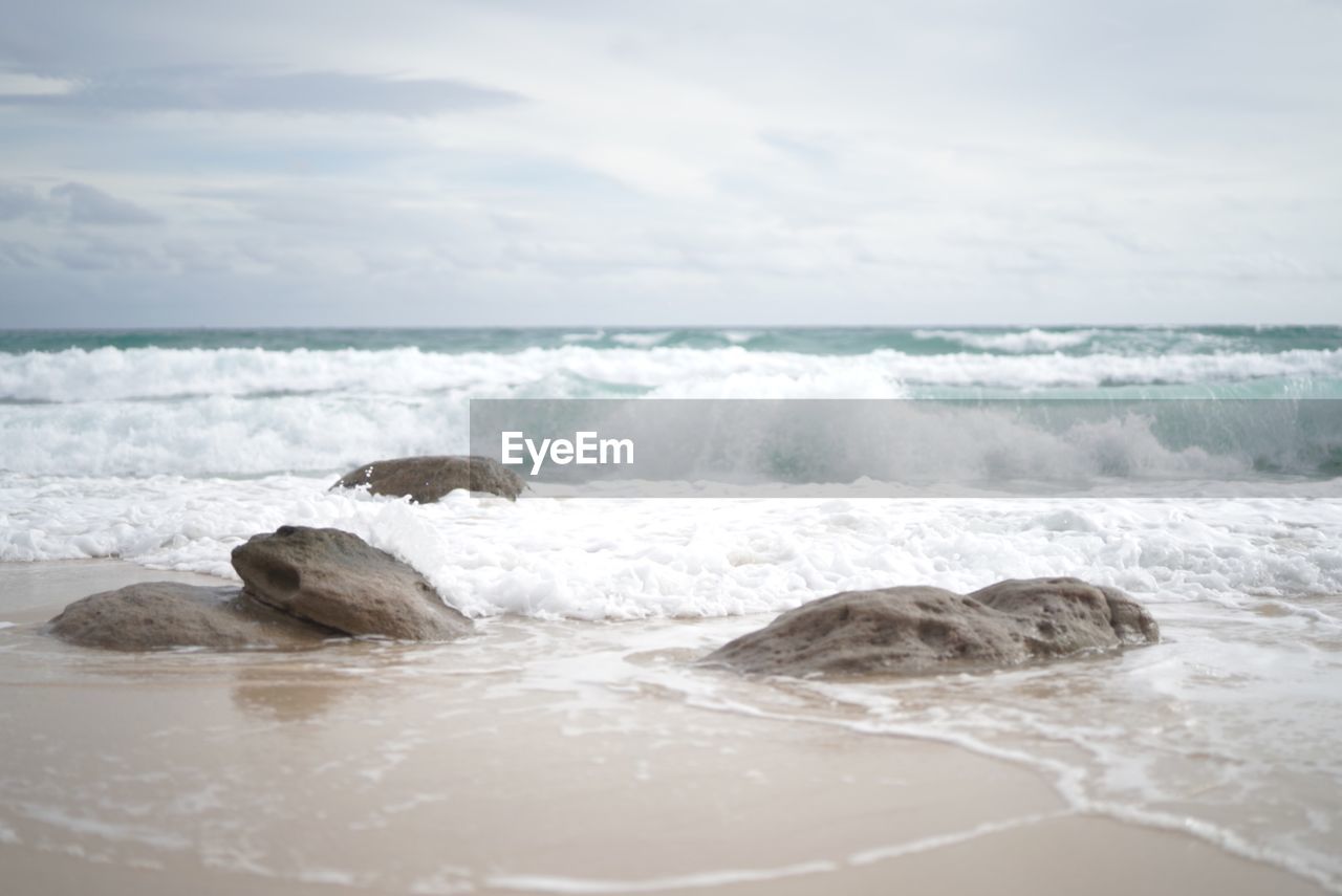 SCENIC VIEW OF WAVES RUSHING TOWARDS SHORE