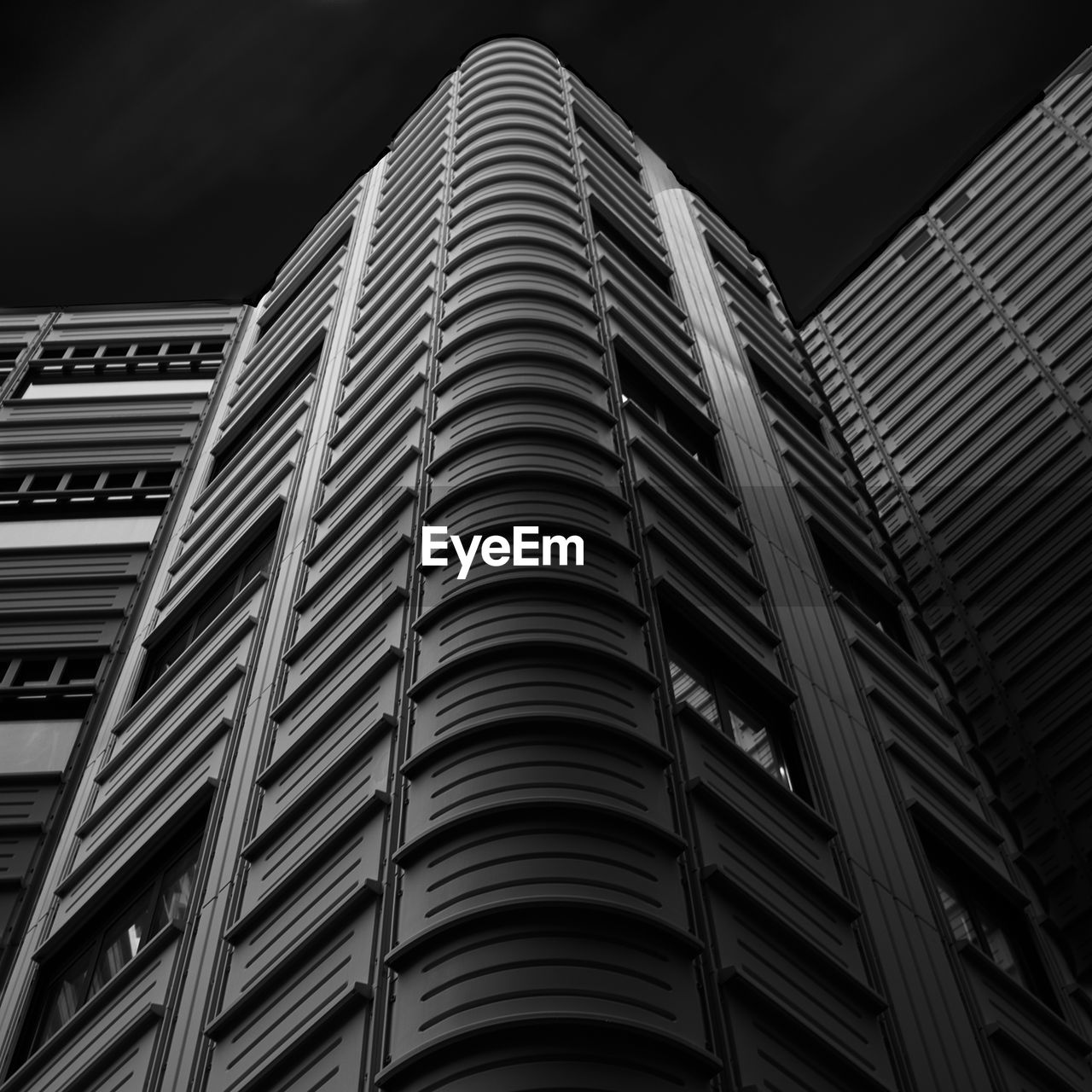 Low angle view of illuminated building against sky at night