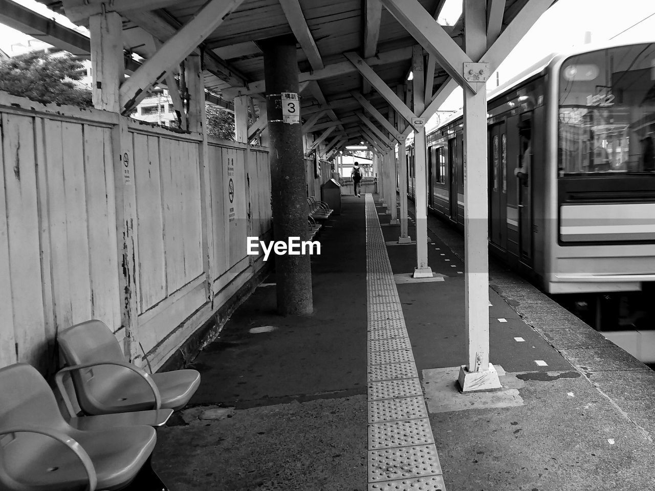 MAN ON TRAIN AT RAILROAD STATION