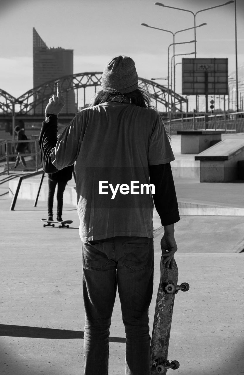 Rear view of men standing in skate park