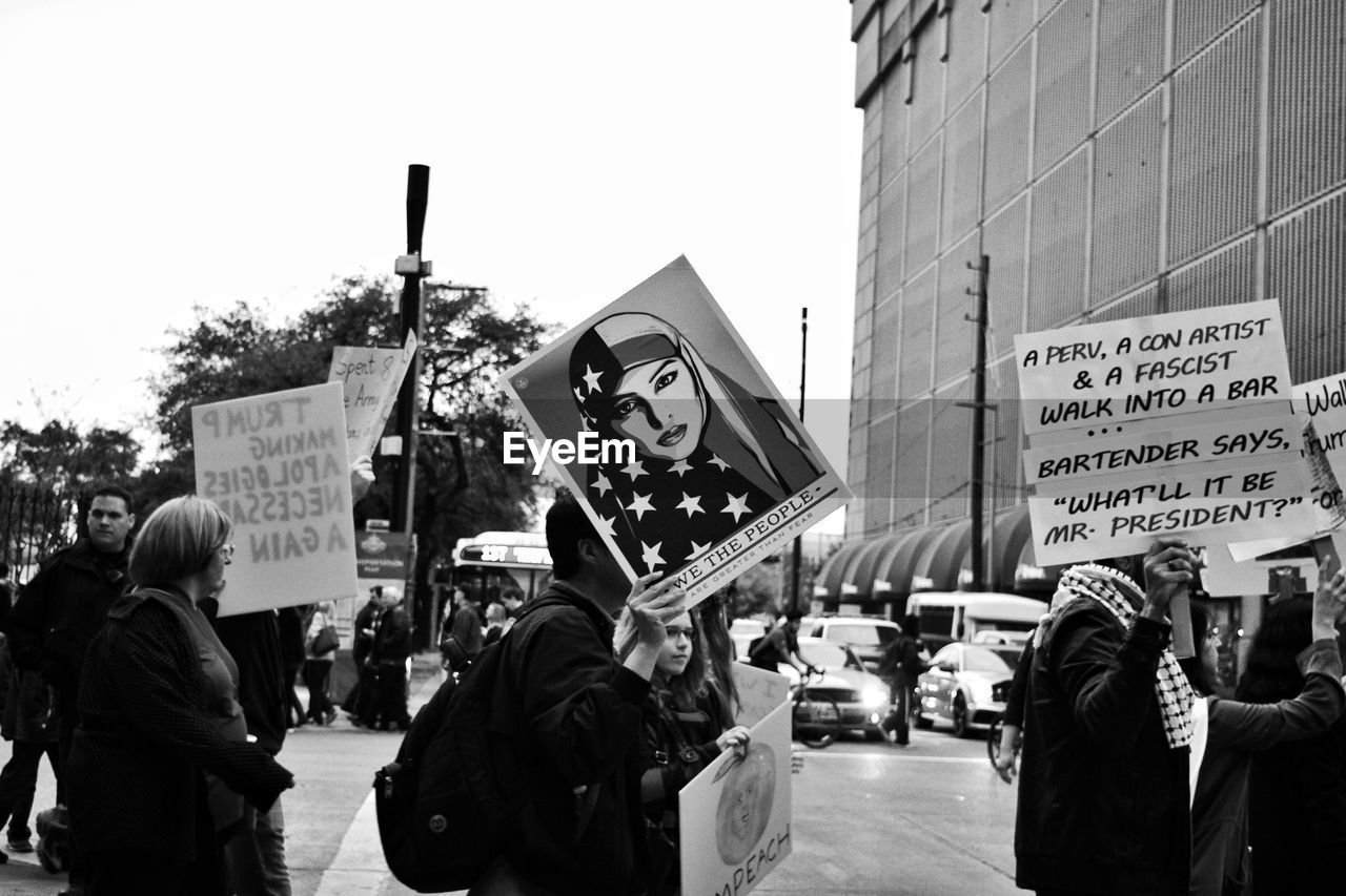 PEOPLE ON STREET AT CITY