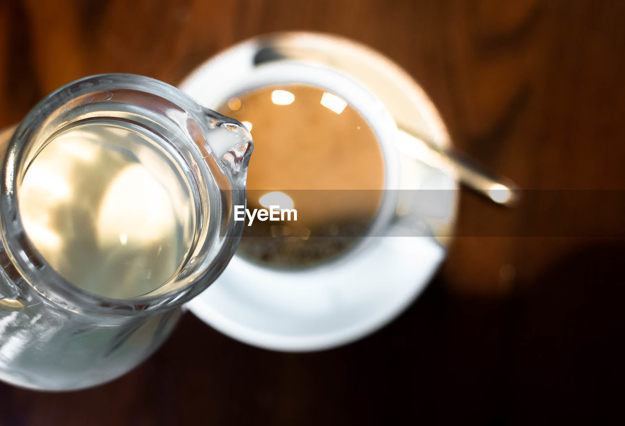 Milk being poured in coffee