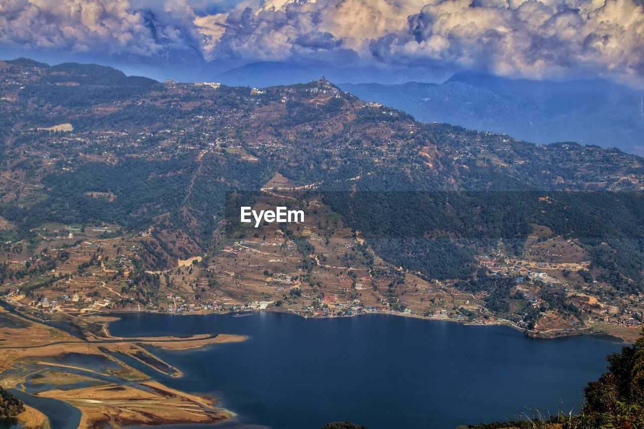 High angle view of sea and mountains against sky