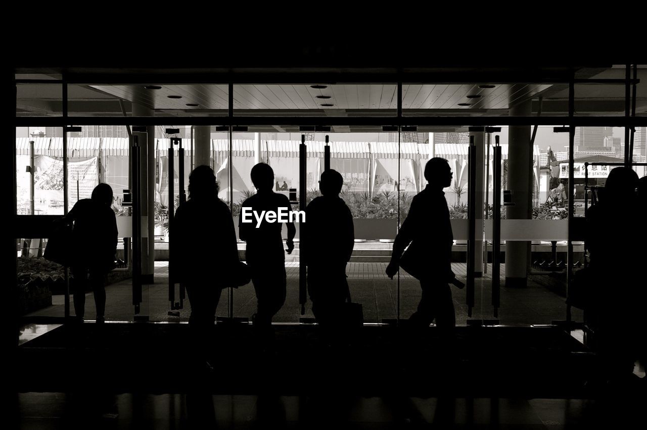 Silhouette people in building