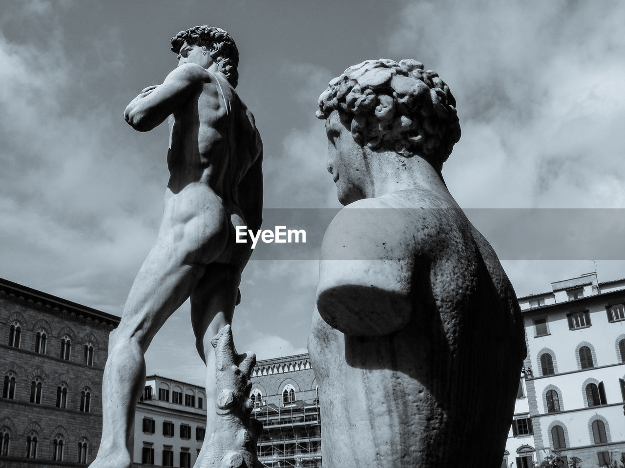 LOW ANGLE VIEW OF STATUES AGAINST SKY IN CITY