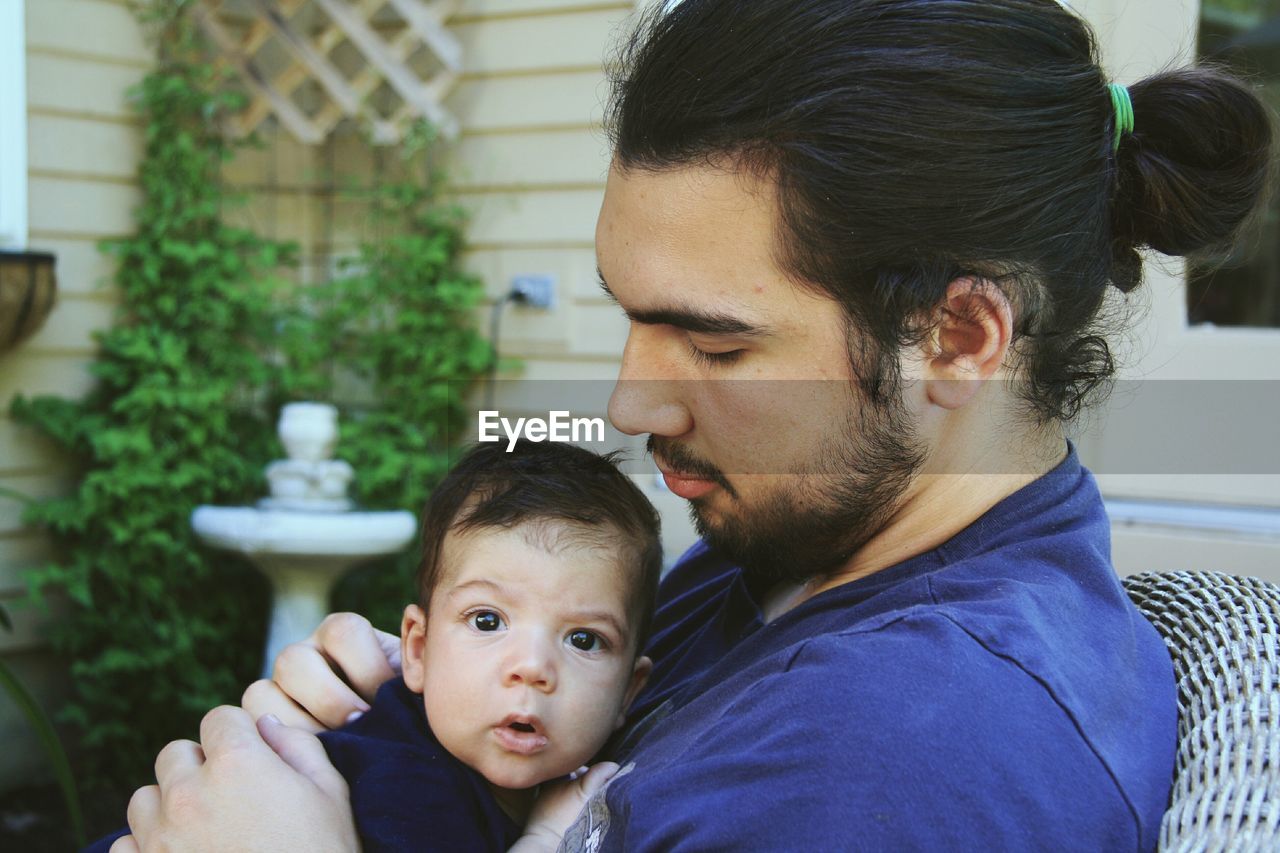 Portrait of cute child with father in yard