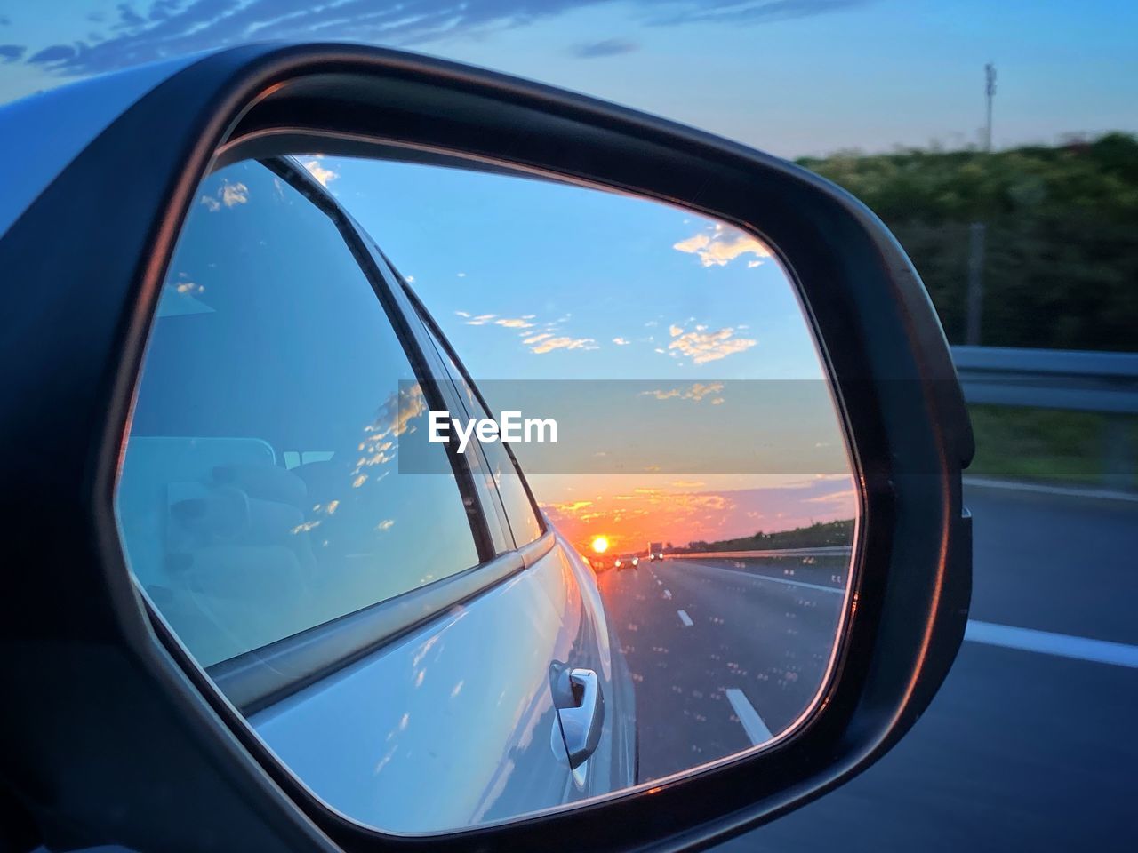 Reflection of sky on side-view mirror