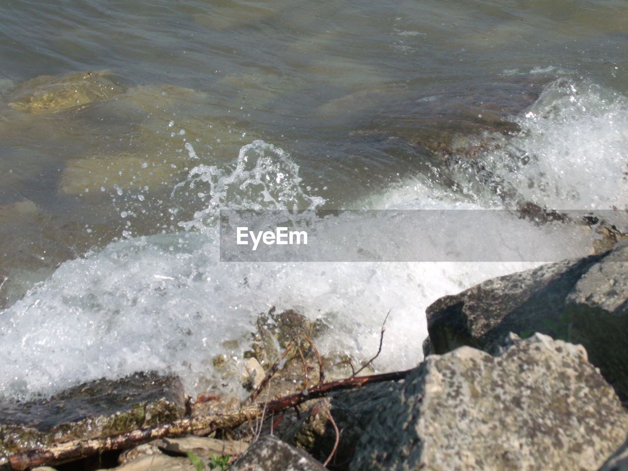 WAVES SPLASHING ON ROCKS AT SHORE