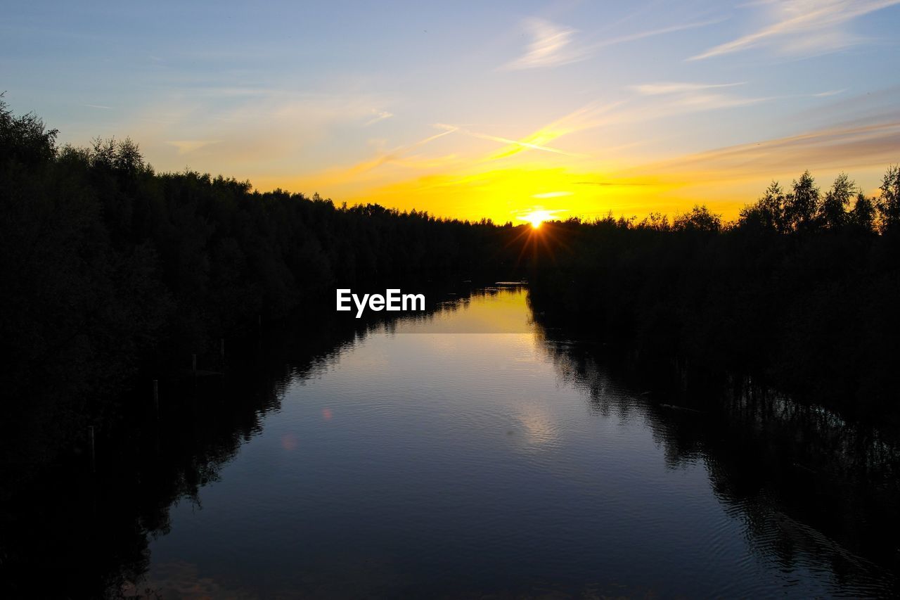 SILHOUETTE TREES BY LAKE AGAINST SKY DURING SUNSET