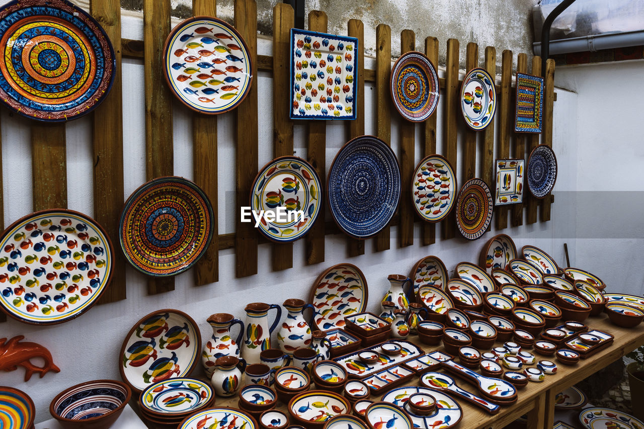 Collection of colorful pottery from a local craft store on display. handmade ceramic gift shop
