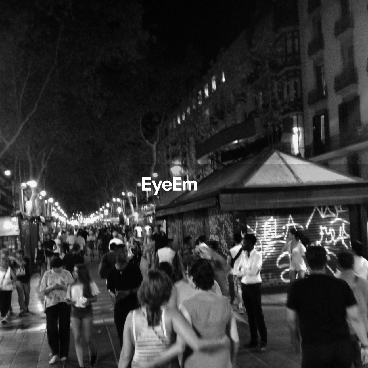 GROUP OF PEOPLE ON STREET AT NIGHT