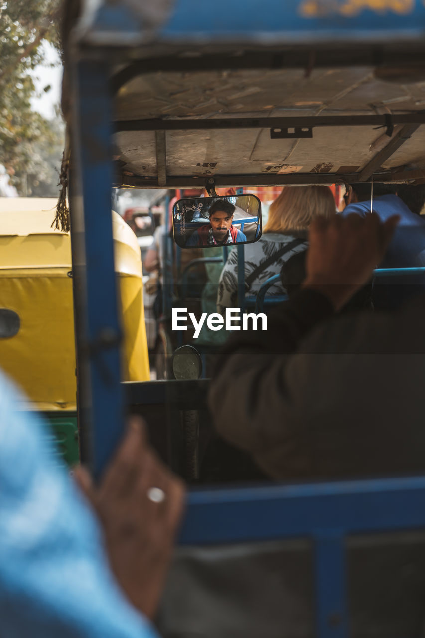 mode of transportation, men, transportation, adult, blue, bus, vehicle interior, selective focus, vehicle, land vehicle, day, focus on background, occupation, rear view, travel, public transportation, outdoors, one person, working, transport