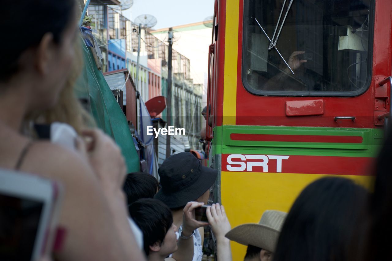 REAR VIEW OF MAN TRAVELING IN TRAIN AT BUS