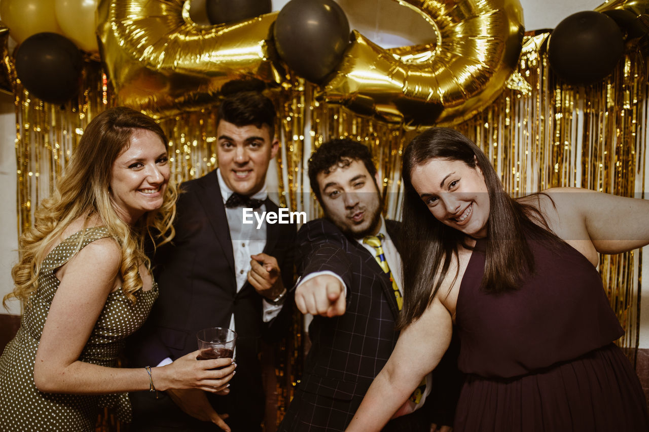 Portrait of smiling young couple enjoying at nightclub