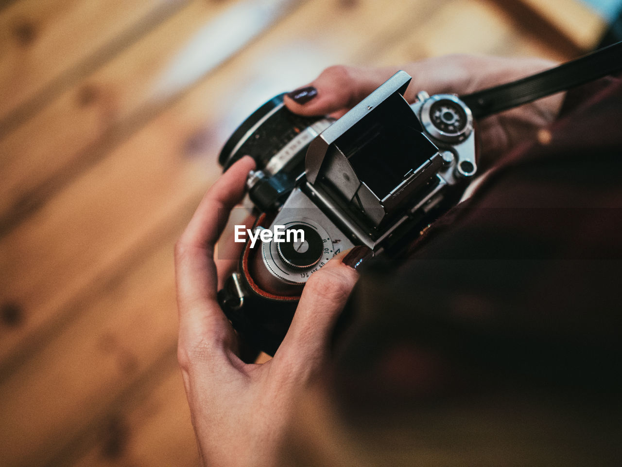 Personal perspective of woman holding vintage camera